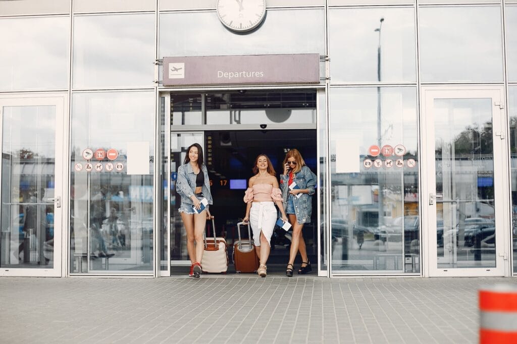 Three beautiful girls standing by the airport
